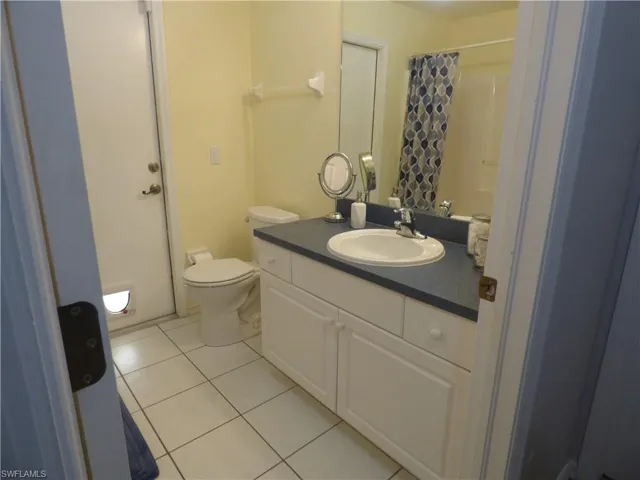 Bathroom with tile floors, vanity with extensive cabinet space and kitty door!