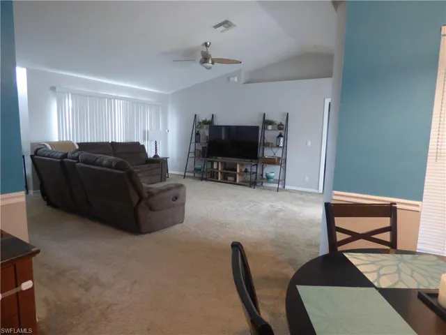 Huge Living room with carpet, ceiling fan, and vaulted ceiling