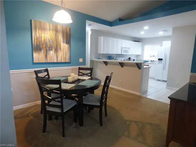 Dining room featuring vaulted ceiling