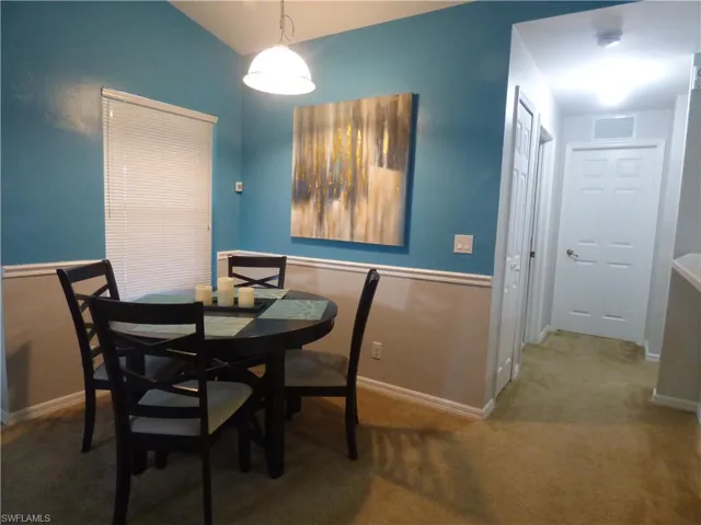 Dining room featuring vaulted ceiling