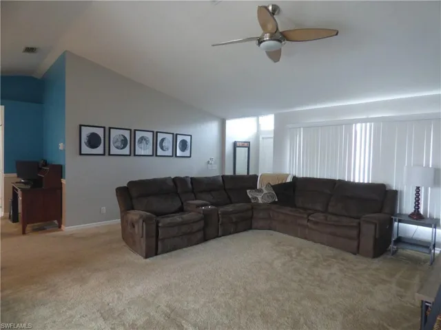 Huge Living room featuring ceiling fan, carpet floors, and vaulted ceiling