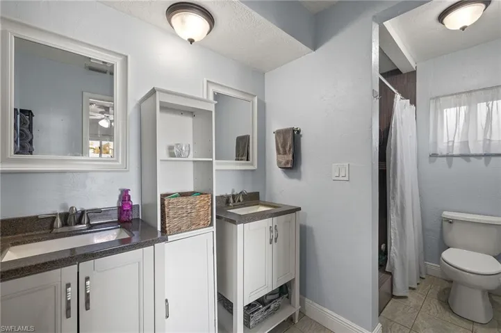 Bathroom with walk in shower, vanity, and toilet