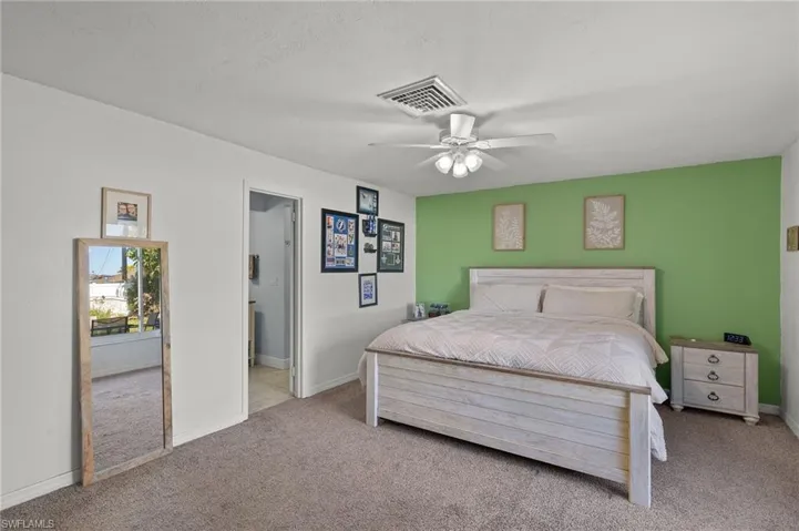 Bedroom featuring light colored carpet and ceiling fan