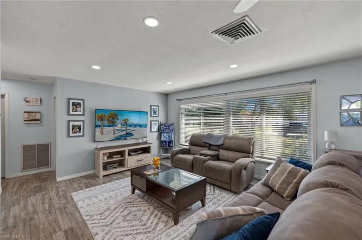 Living room featuring light hardwood / wood-style flooring and a textured ceiling