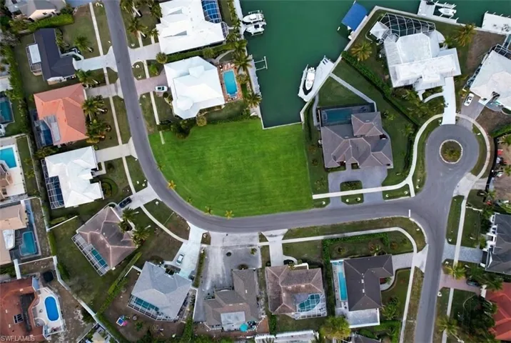 Aerial view of property's location featuring nearby suburban area and a nearby body of water