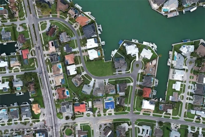 Aerial overview of property's location with a large body of water and nearby suburban area