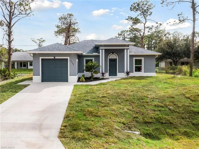 Prairie-style house featuring a garage and a front yard