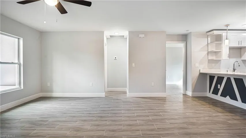 Living room featuring ceiling fan and light hardwood/wood-style floors
