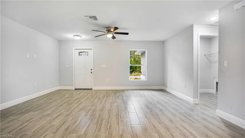 Living room featuring ceiling fan and light wood-type flooring