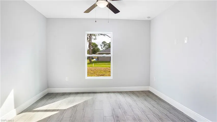 Empty room featuring ceiling fan and light wood-type flooring