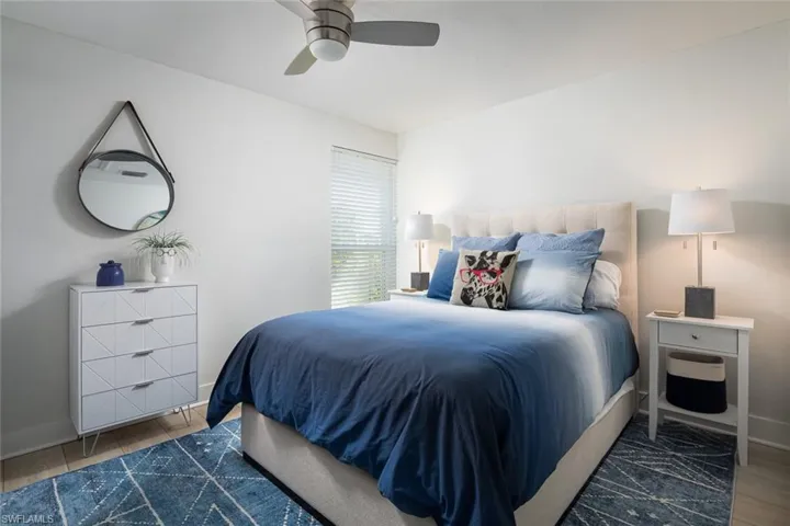 Bedroom with dark hardwood / wood-style flooring and ceiling fan