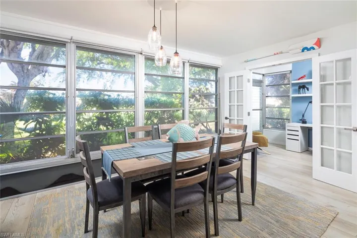 Sunroom featuring french doors and a healthy amount of sunlight