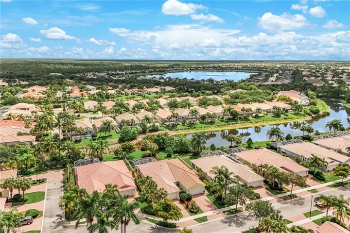 Expansive aerial perspective showcasing a residential community with water features and lush landscaping