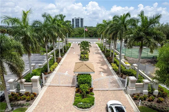 Royal Palms line the entrance of this Gated Community.