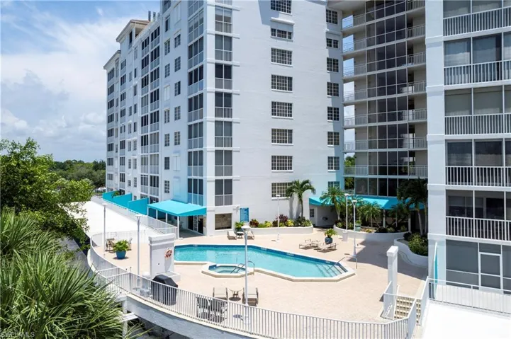 Elevated 2nd floor large pool with community room and bathrooms next to it.