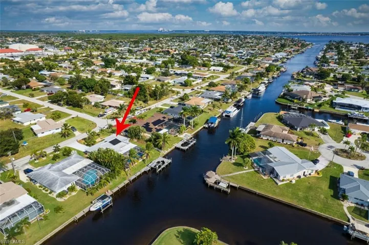 Aerial view of property's location with nearby suburban area and a nearby body of water