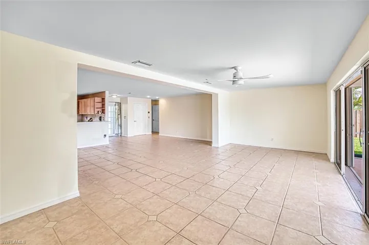 Spare room featuring a ceiling fan and light tile patterned flooring