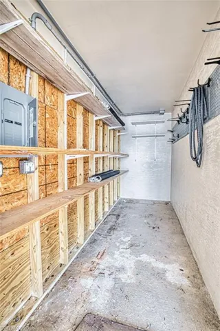 Storage room featuring electric panel. Great workshop or man cave.