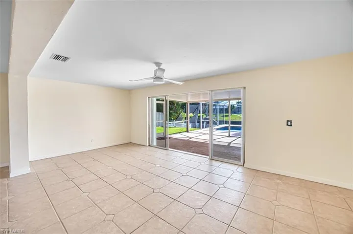 Spare room with ceiling fan and light tile patterned floors