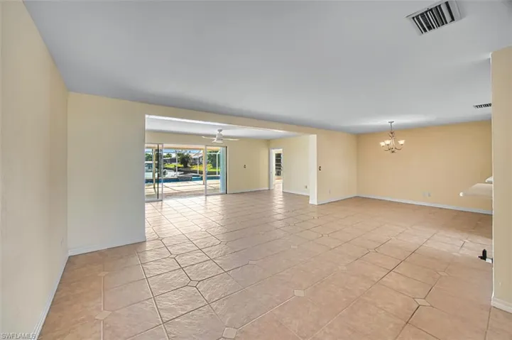 Spare room featuring a chandelier and ceiling fan