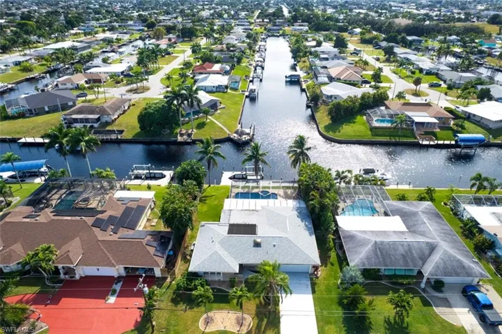 Aerial perspective of suburban area featuring a large body of water
