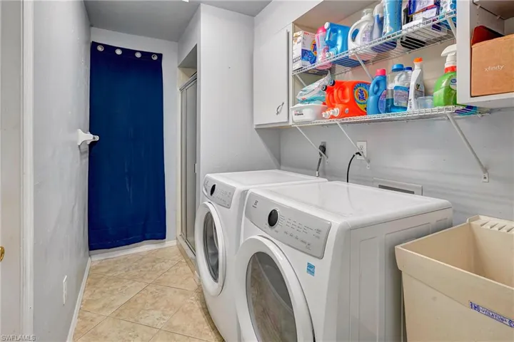 Laundry room with mud sink & storage.