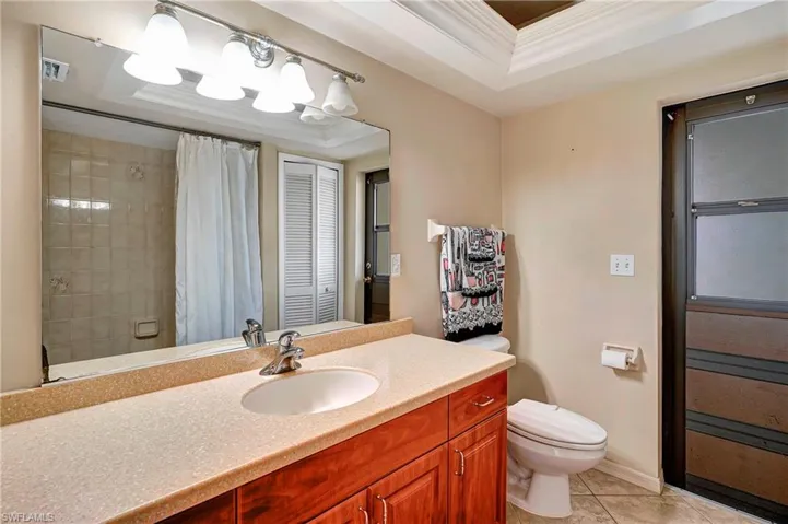 Guest bathroom with entrance to lanai. Lanai is ready for a pool.