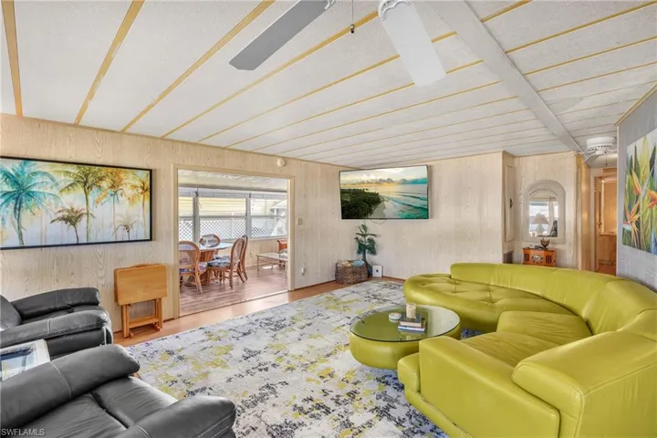 Living area with wood finished floors and wooden walls