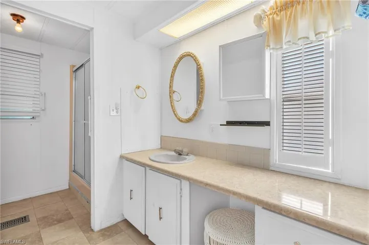 Bathroom featuring vanity and a stall shower
