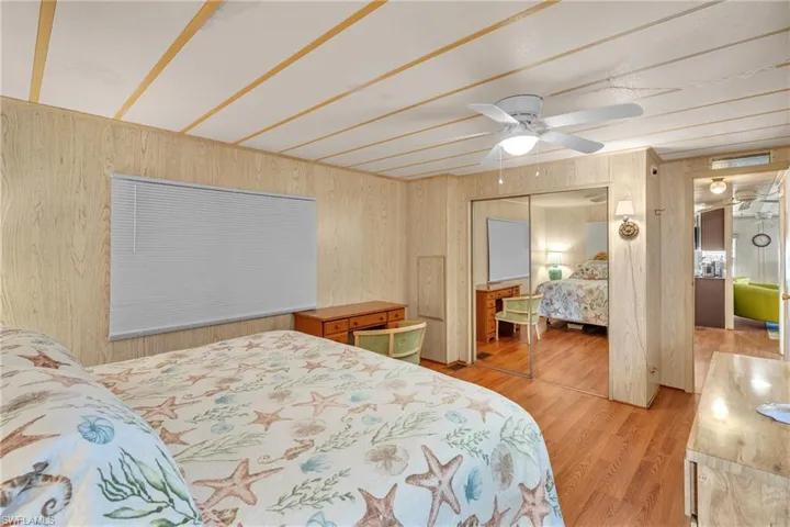 Bedroom with light wood-style floors, a closet, and a ceiling fan