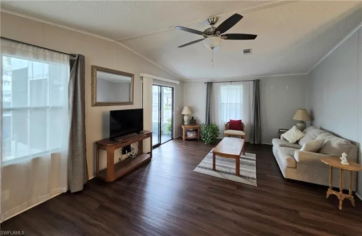 Spacious Living area features high ceilings and crown molding. Lots of natural light!