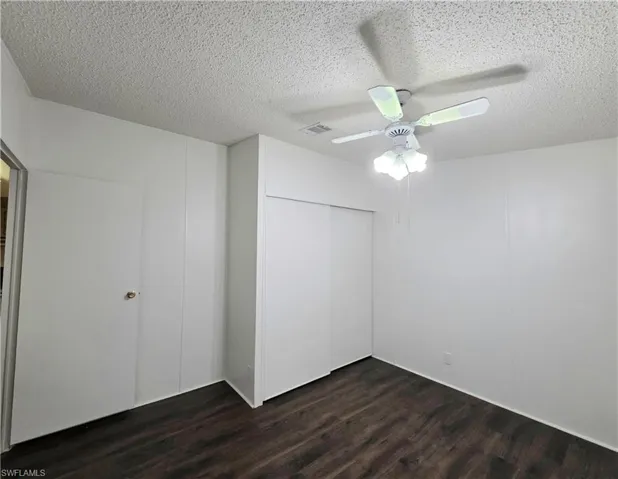 Guest Bedroom with wood-finish flooring and ceiling fan.