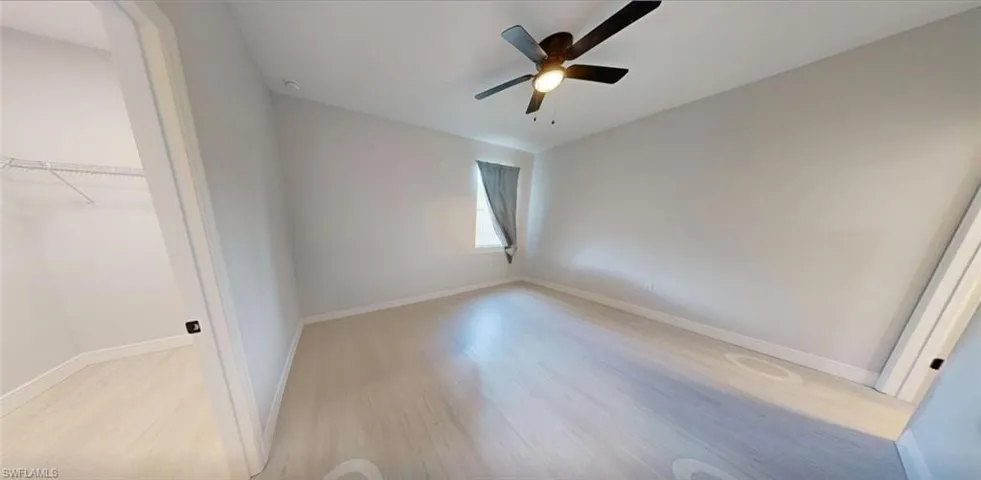 Unfurnished bedroom featuring light wood-type flooring and a ceiling fan