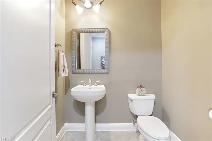 Bathroom with baseboards and tile patterned floors