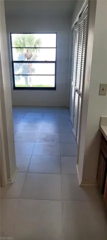 Bathroom with tile patterned flooring, washtub / shower combination, visible vents, and toilet