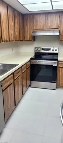 Hallway with light tile patterned floors and baseboards