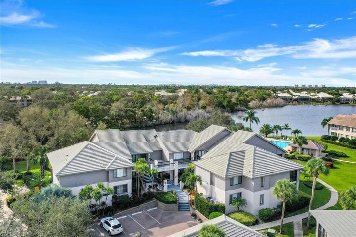 View of home (end unit on left) with pool and lake in the background.
