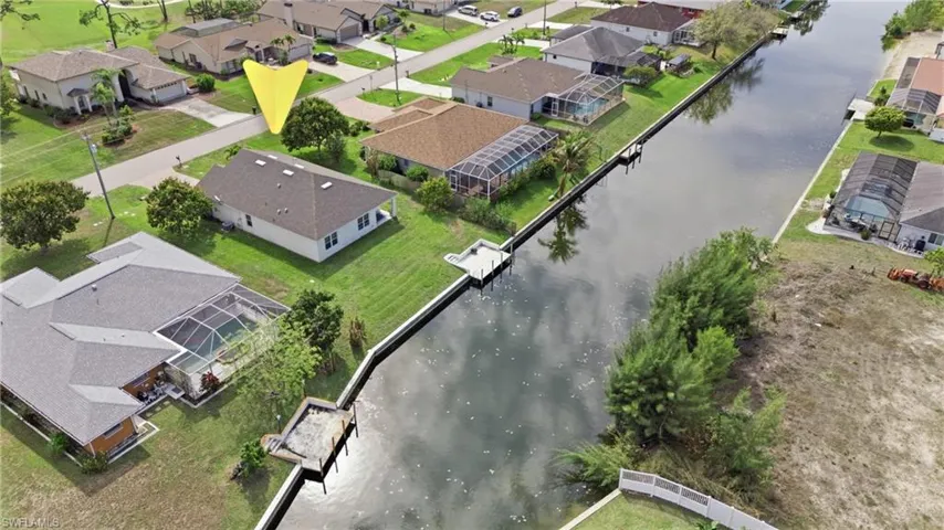 Aerial view of residential area featuring a large body of water