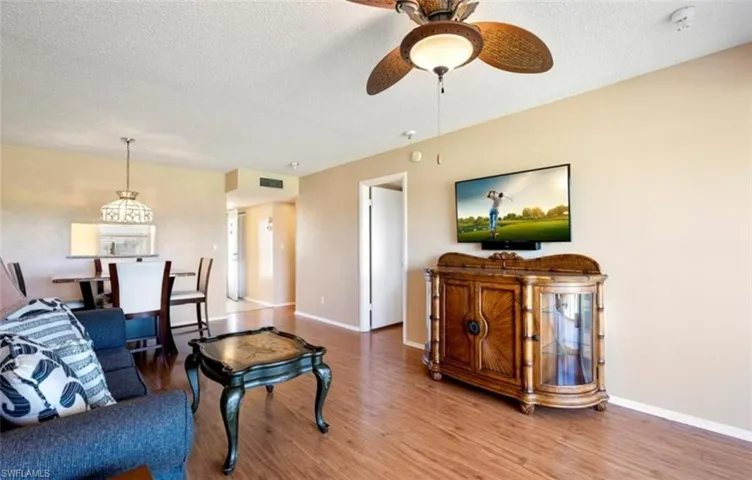 The property features hard surface flooring, a ceiling fan with integrated lighting, and neutral-toned walls