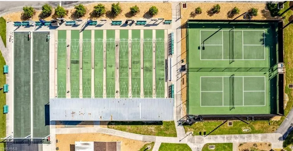 The property offers recreational amenities including two green hard-surface courts with nets, several green shuffleboard courts, and a long green lawn area