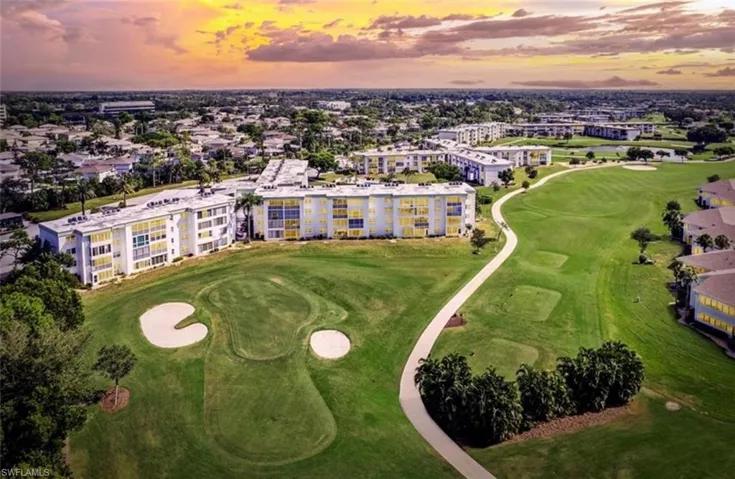 The property offers views of a golf course with sand traps and a winding path, surrounded by mature trees and lush green lawns