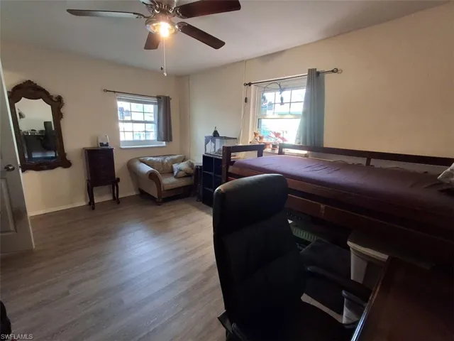 Bedroom with ceiling fan and wood-type flooring