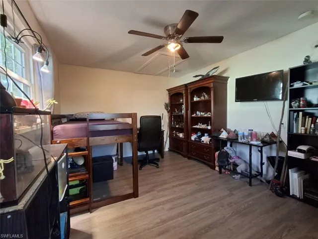 Office featuring hardwood / wood-style floors and ceiling fan
