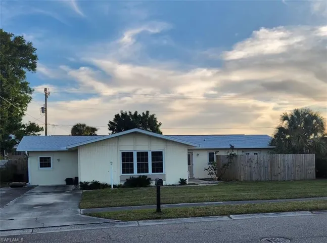 Ranch-style home with a yard