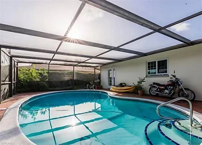 View of pool featuring a lanai