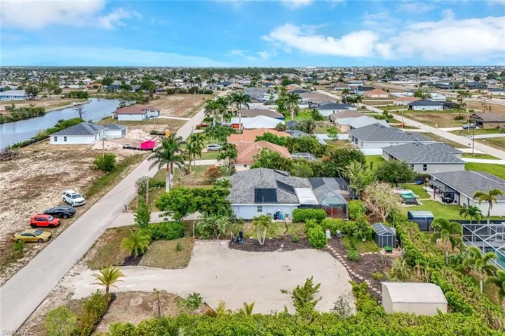 Aerial perspective of suburban area featuring a nearby body of water