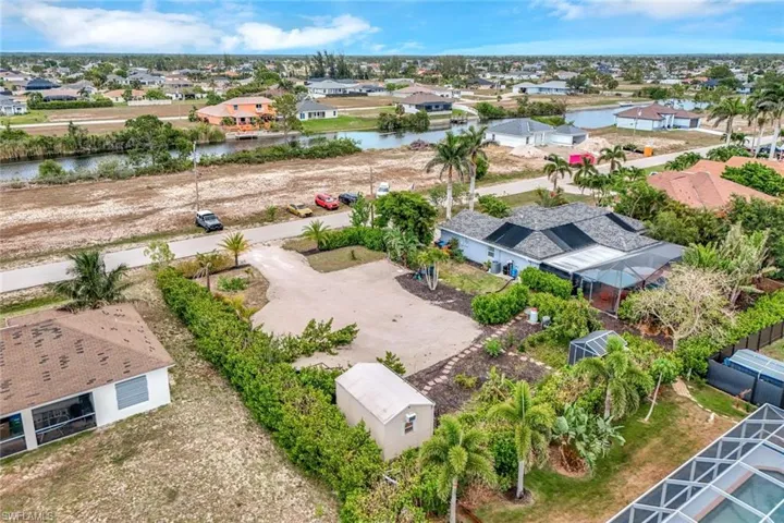 Aerial perspective of suburban area featuring a nearby body of water
