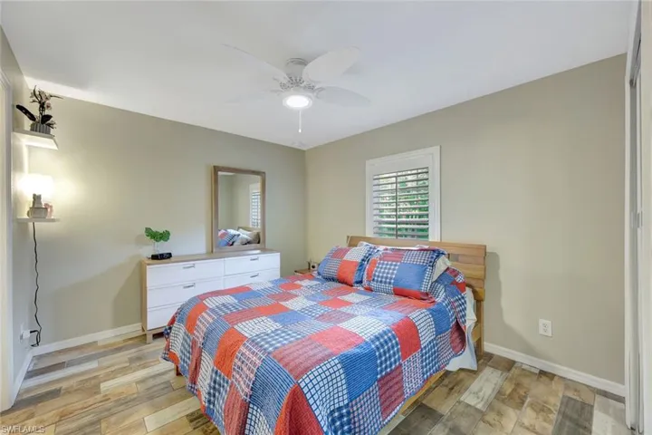 Bedroom with light wood-style flooring, baseboards, and ceiling fan