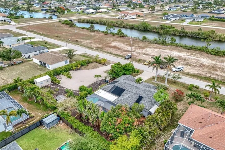 Aerial perspective of suburban area featuring a large body of water
