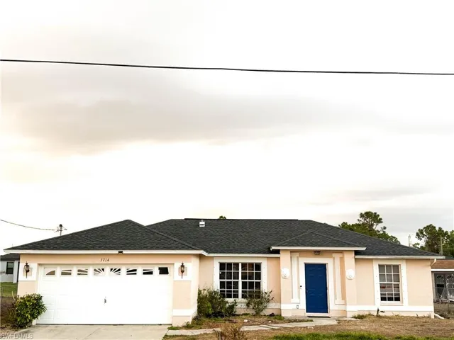 Single story home with driveway, stucco siding, a garage, and roof with shingles